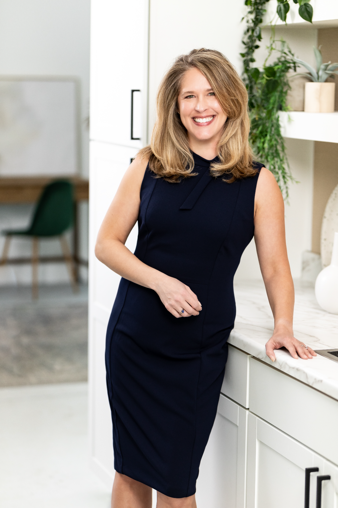 Andrea Scanlon, team lead and REALTOR® at RE/MAX Elite, smiling in a navy dress